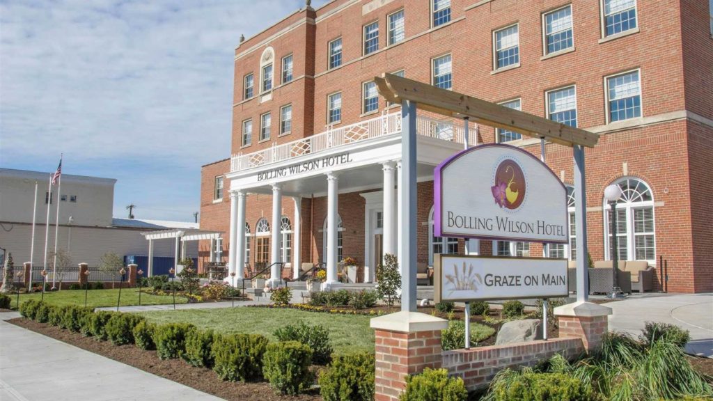 The Bolling Wilson hotel has a reddish brick façade with white pillars supporting a portico.