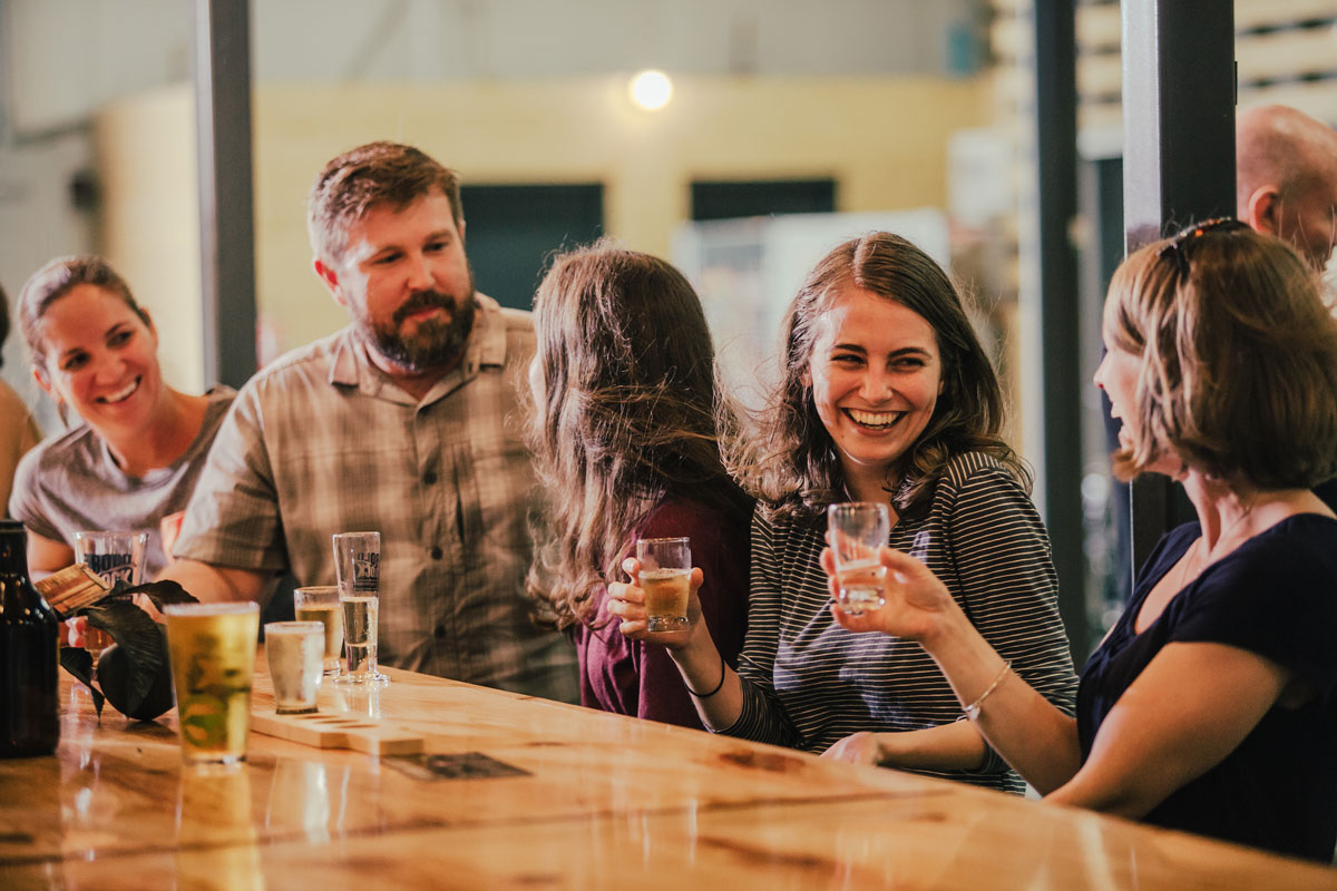 Friends gather at a Henderson County brewery for drinks.