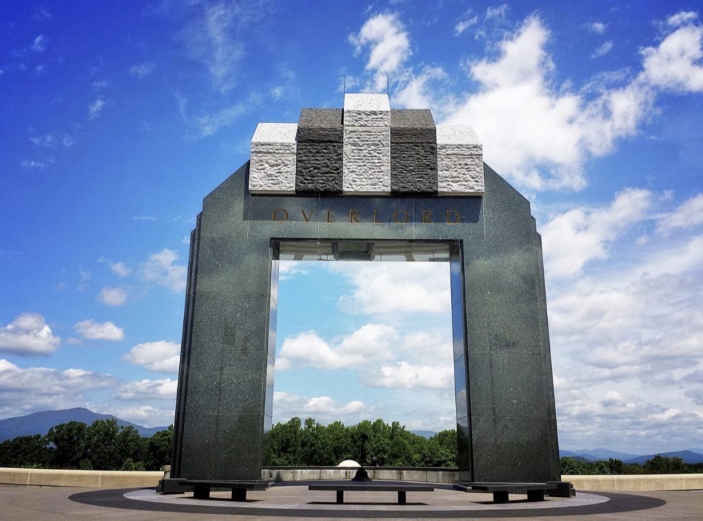 The arch at the National D-Day Memorial is striking against a blue sky.
