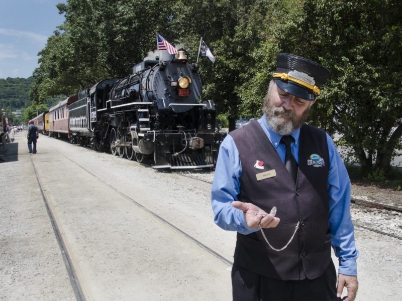 A train conductor checks his watch at the Great Smoky Mountains Railroad in Bryson City, North Carolina