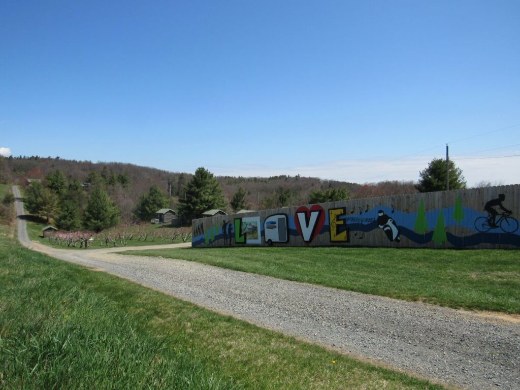 LOVE sign painted on the fence at Fancy Gap Cabins & Campground
