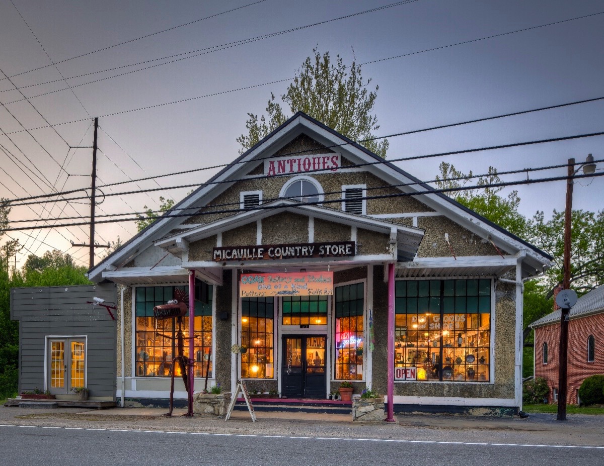 OOAK Art Gallery in Micaville is brightly lit at dusk.