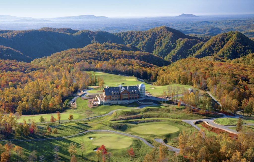 Primland Resort's grassy golf course and buildings are surrounded by fall color on the mountain peaks.