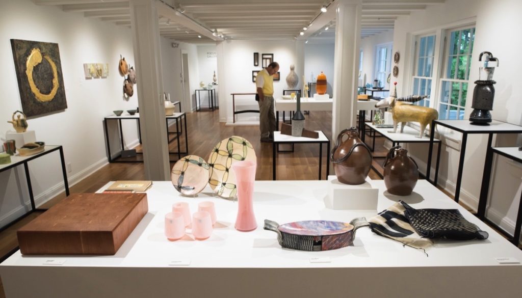A man browses through handmade items at the Penland School of Crafts Gallery.