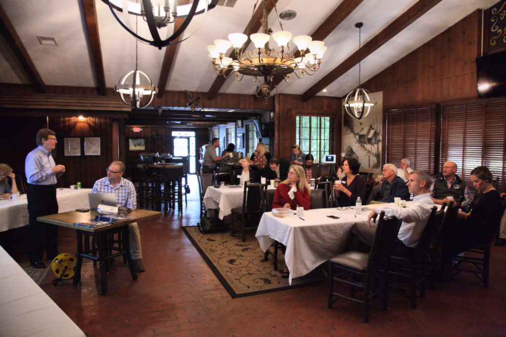 A presenter gives a talk in the meeting room at Switzerland Inn.