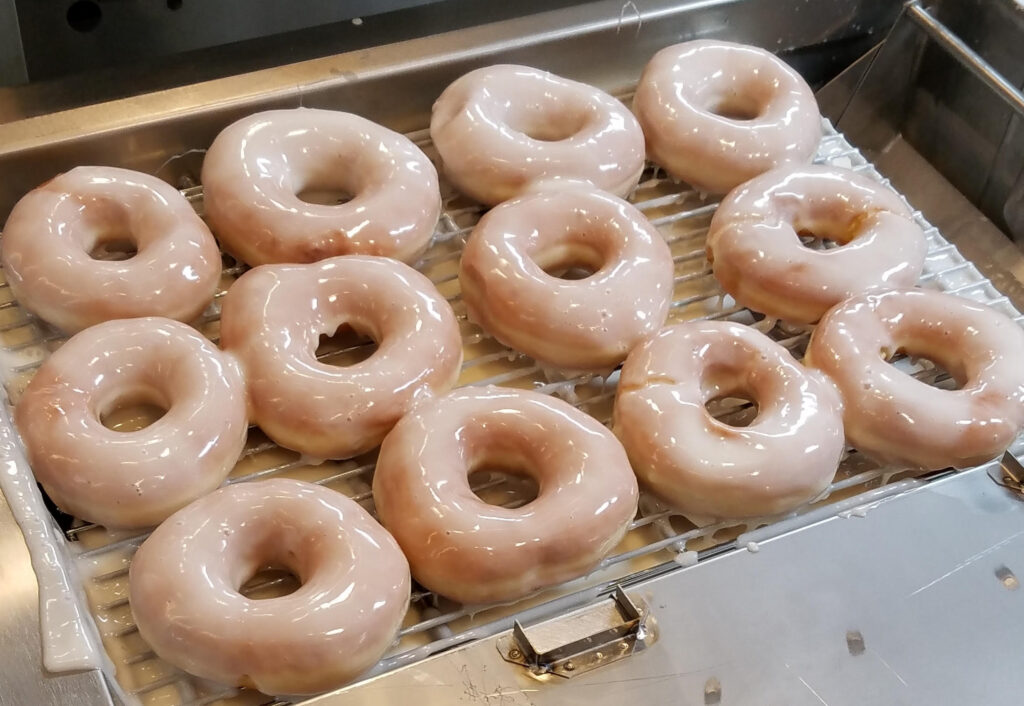 12 glazed doughnuts on a tray