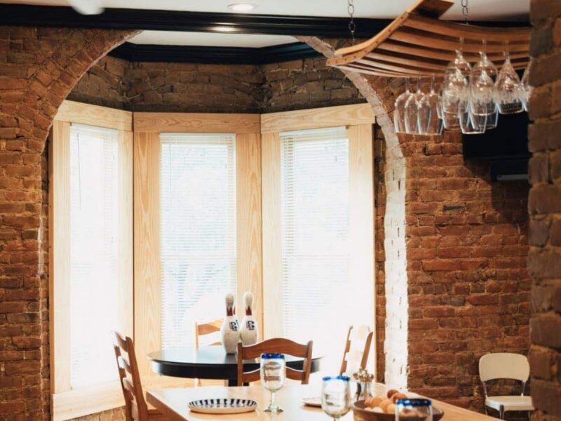 Large windows overlooking a dining table at Roanoke Boutique Hotel