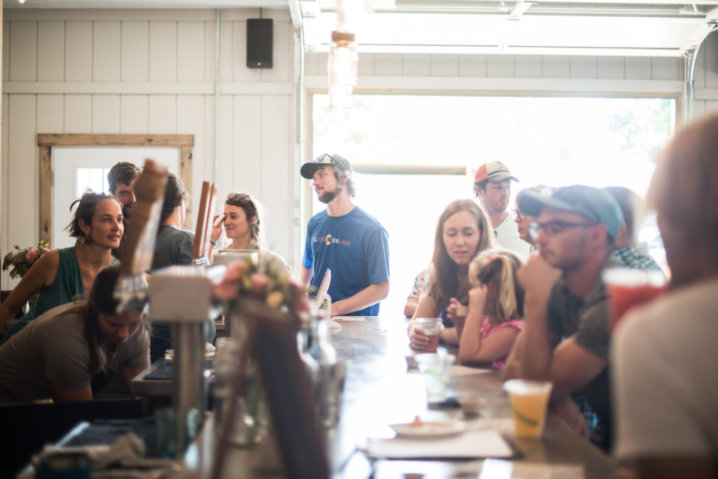 Waynesboro Group Itinerary photo of patrons gathered around a bar by Cappy Phalen.