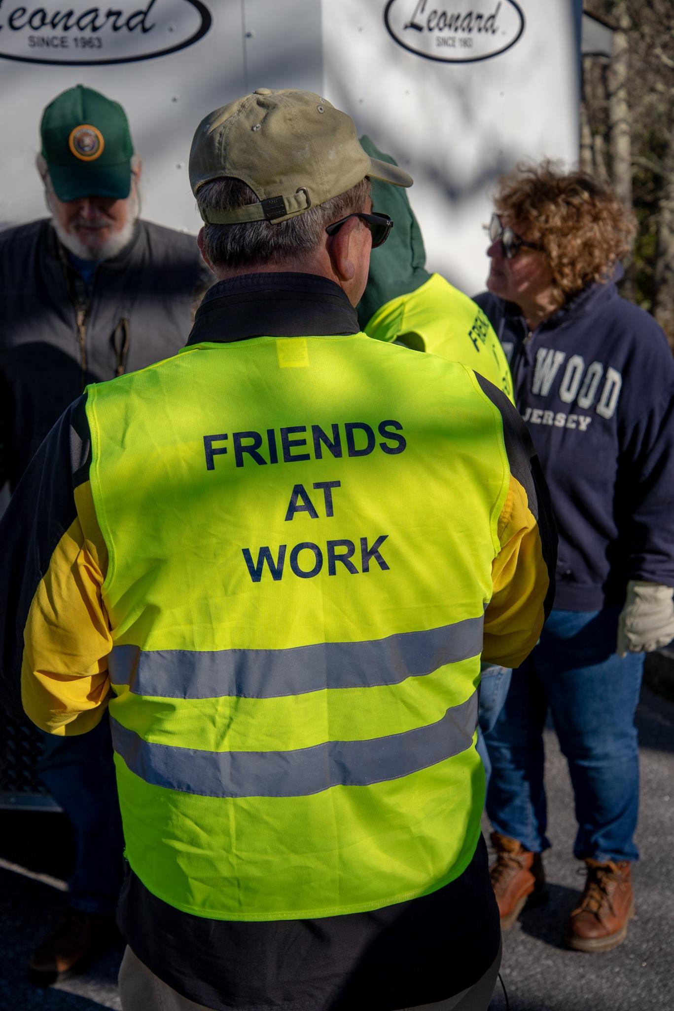 Volunteers wear yellow vests during the Project Parkway cleanup event.