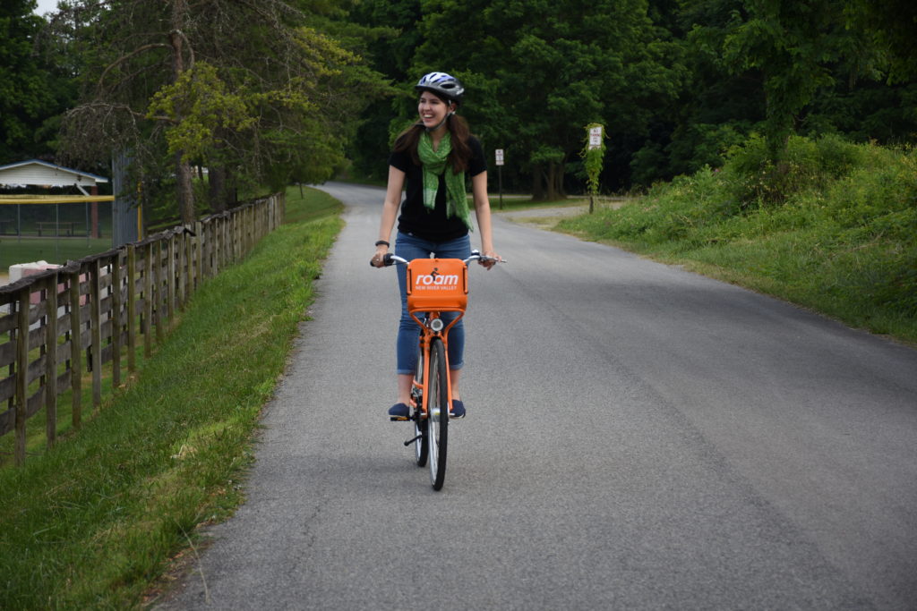 A Montgomery County cyclist rides on a wide paved trail.