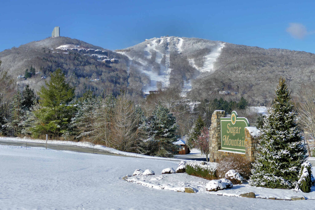 Snow coats the slopes at Sugar Mountain showing the downhill ski runs on the slope.