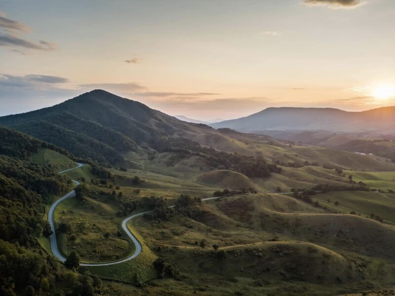 The sun setting over a curvy road in the mountains of VA