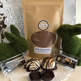 A selection of hot cocoa mix and other chocolates available at Cocoa Mia Chocolates.