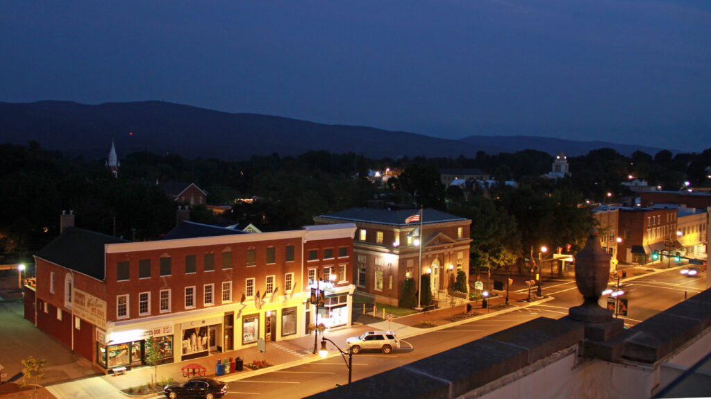 Downtown Wytheville, VA glows at night with streetlights illuminated against the night sky.