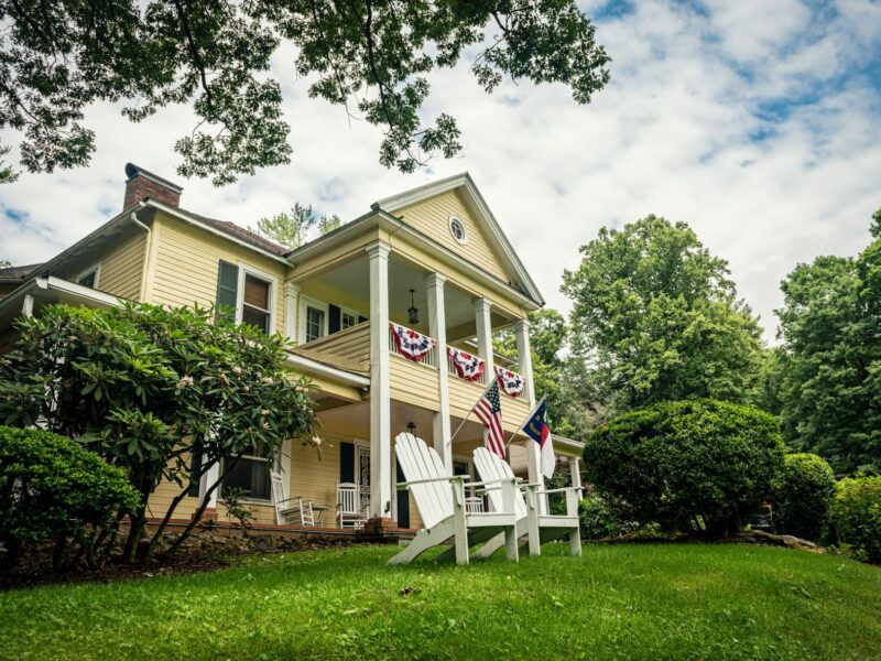 Flags wave in front of The Yellow House bed and breakfast