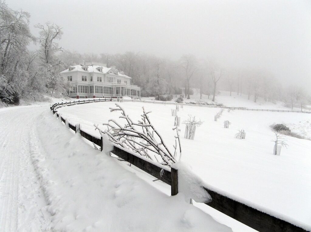 The snowy driveway leads to Moses Cone Manor in winter.
