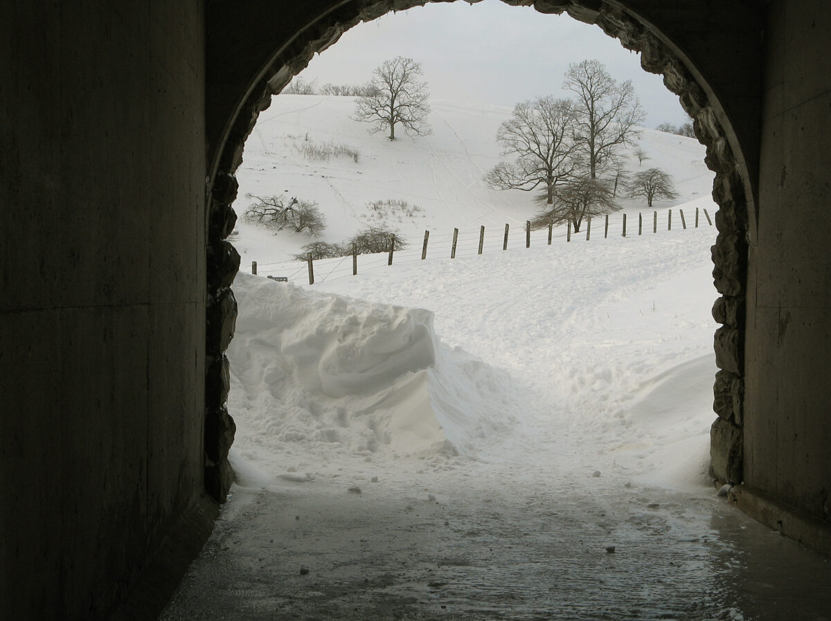 Thick snow blankets the Parkway outside an arched tunnel entrance.