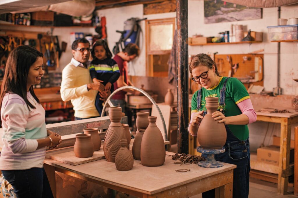 A potter uses a pottery wheel in her studio.