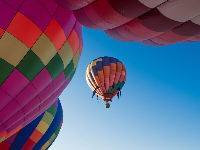 Brightly colored hot air balloons lift off from the ground in Rockbridge County, Virginia