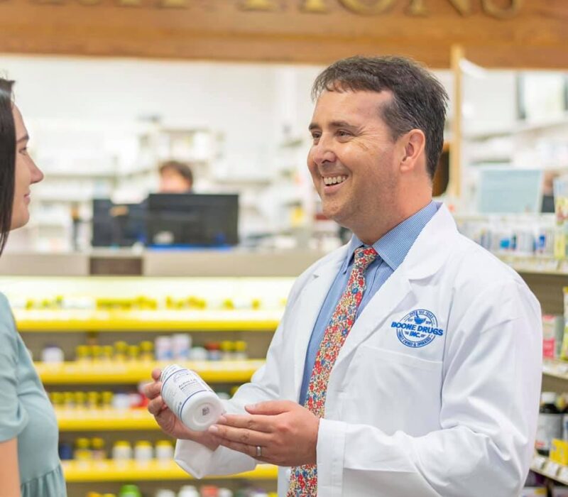 Corey Furman assist a customer at a Boone Drugs pharmacy.