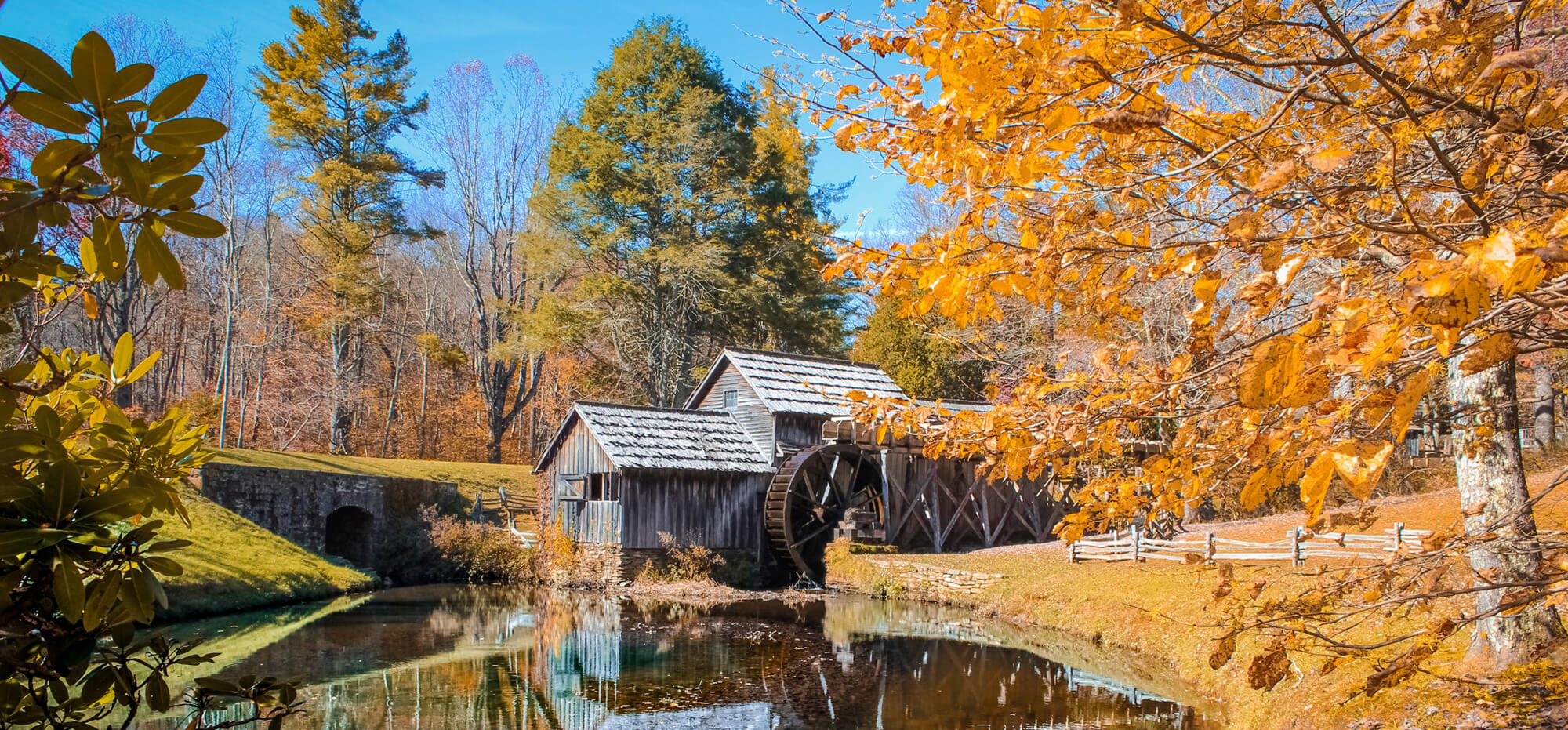 a watermill surrounded by fall colors