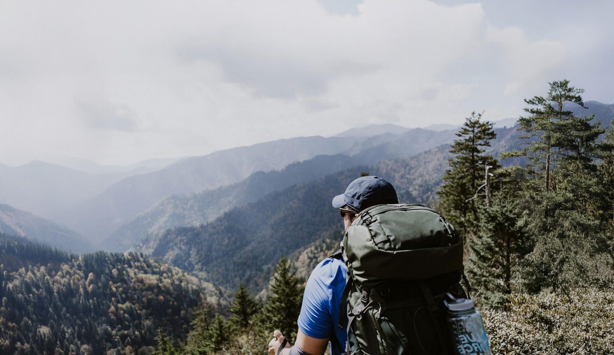 a backpacker admires the mountain views of the blue ridge parkway