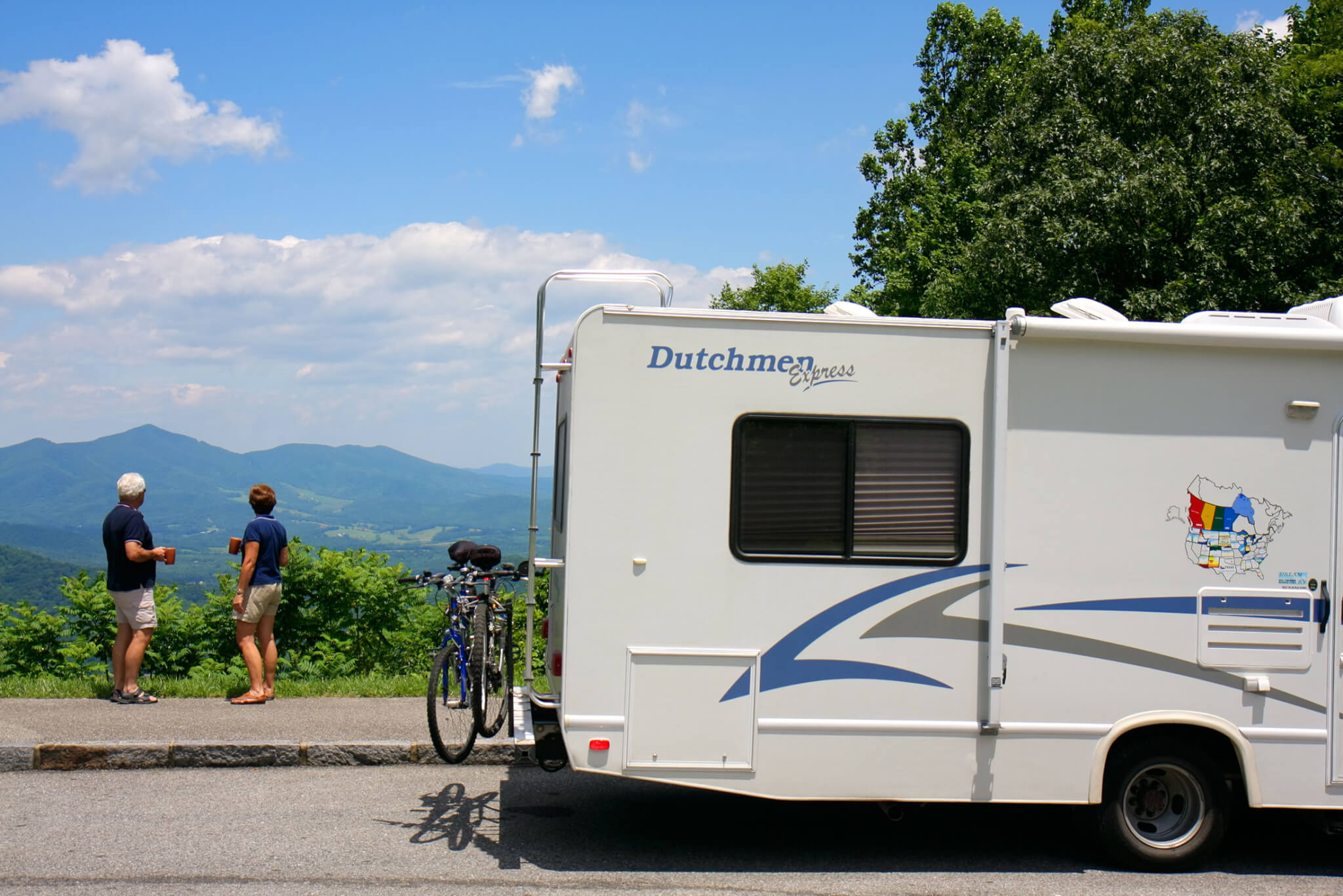 a couple rving admires a view from the blue ridge parkway